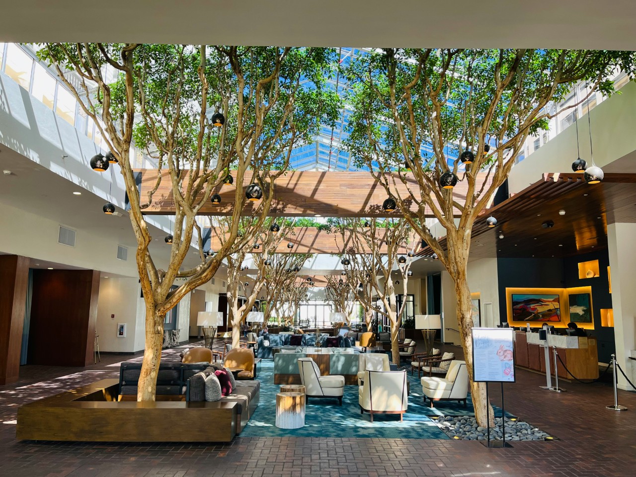 Photo by <a href="https://unsplash.com/@ewgino?utm_source=unsplash&utm_medium=referral&utm_content=creditCopyText">Gene Giromini</a> on <a href="https://unsplash.com/photos/a-lobby-with-a-lot-of-couches-and-trees-GQT9PtnuFn4?utm_source=unsplash&utm_medium=referral&utm_content=creditCopyText">Unsplash</a>       